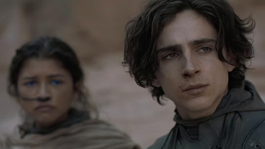 Paul Atreides in his stillsuit in front of Chani in hers out in the desert in Dune: Part One