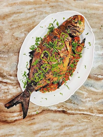 A grilled pompano on a plate.
