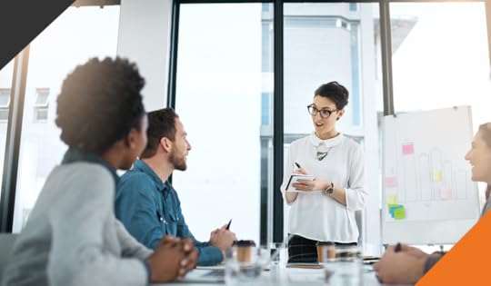 image of 4 employees in a meeting room reviewing how purpose can improve performance