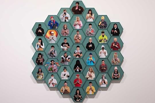37 self-portraits by the artist in various guises mounted to hexagonal green wood frames