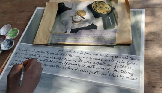 Color photo of a montage of photographs of Lincoln's personal objects and hand lettering of some of his writings.