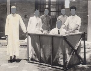 Five men baptizing a man in a canvas baptismal font.