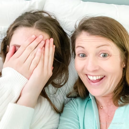 Marilee and Amy Julia take a selfie with Marilee hiding her face with her hands and Amy Julia smiling widely at the camera