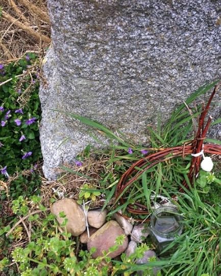wicker offering at the witch stone beside wild violets