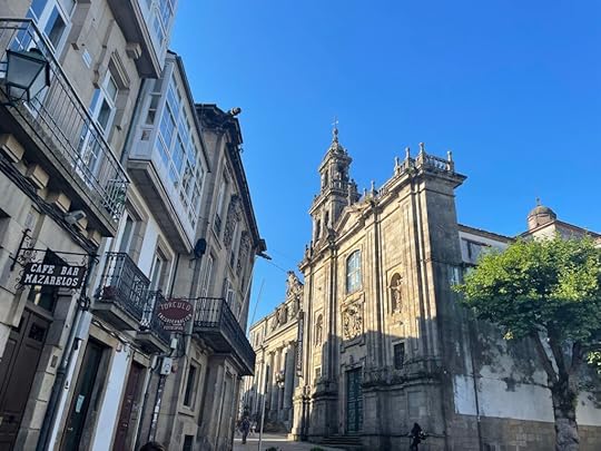 Intricately sculpted stone buildings in a street in Santiago, the shadows of the buildings on one side of the narrow street casting across the buildings on the other side