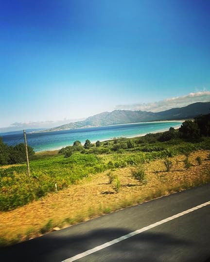 Monte Pindo rises up behind crystal clear green-blue water and white sand beaches