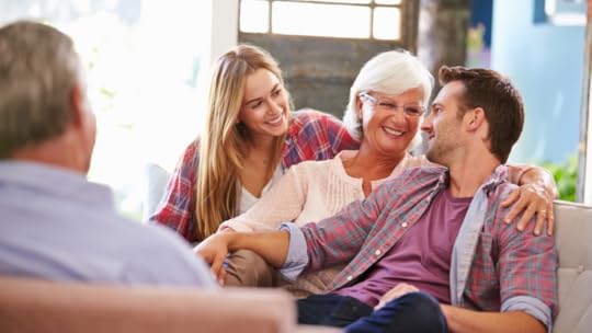 An image of adults kida and their parents having a couch conversation on how they can declutter and downsize their parents' house.