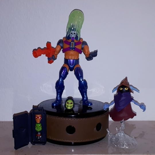 Man-e-Faces wears the skull face covered with acid, while Orko looks on.