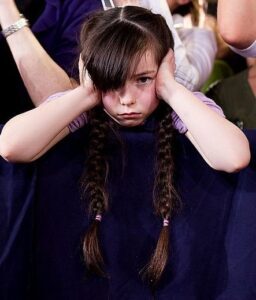 GIRl with fingers in her ears