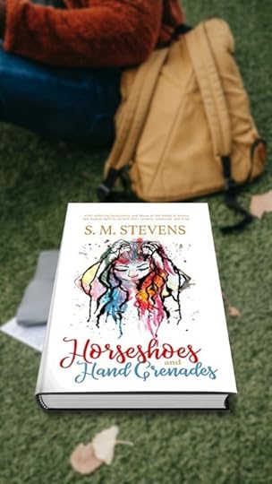 book horseshoes and hand grenades on lawn in front of a college student's backback