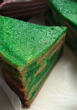 A bright green piece of spekkoek, Indonesian layer cake, tempts the viewer with its lush colour that you can almost taste. It looks dense but oh so good. Is your mouth watering yet?