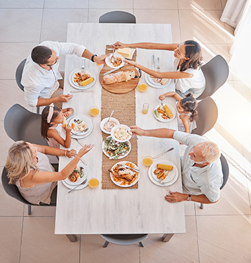 Overhead photo of an extended family eating together at a table.