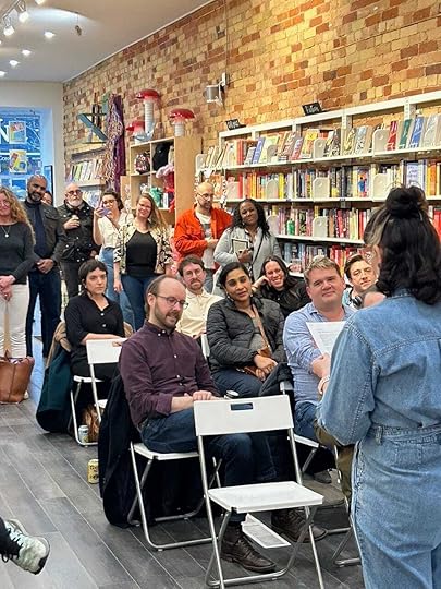 Poetry reading at Bookstore. Full audience with one empty chair.