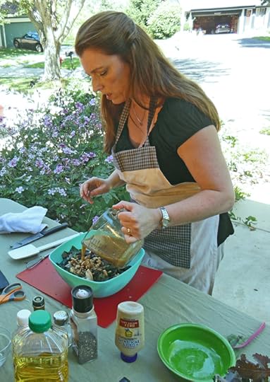 Shawna Coronado adding salad dressing to kale and swiss chard salad.
