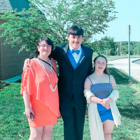 Penny poses with her friends at prom