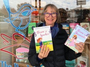 Amber Jakeman outside the Book Nest in Mudgee with two of the House of Jewels series books