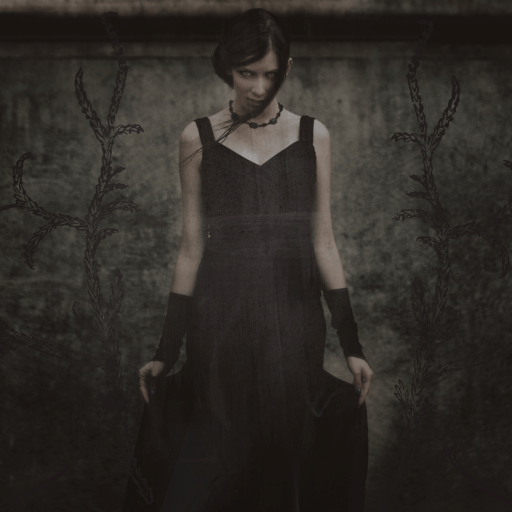 Creepy pale woman in a black dress stares down the camera