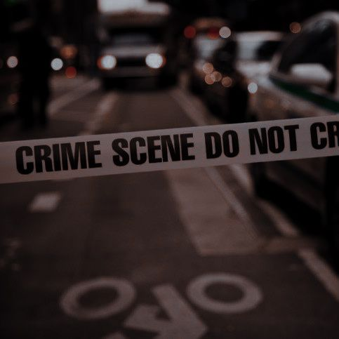 crime scene tape over a roadway.