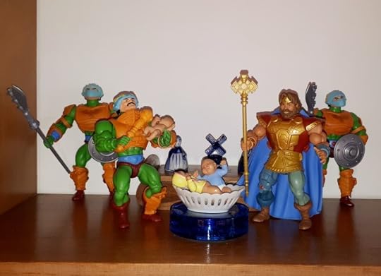 Duncan holds baby Teela, while Randor stands over a cradle with babies Adam and Adora.