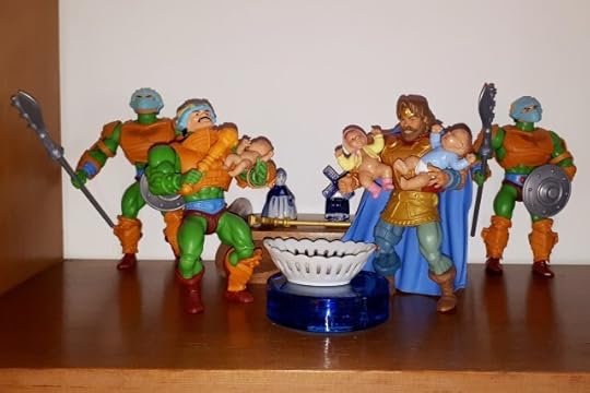 Randor holds babies Adam and Adora, while Duncan holds baby Teela.