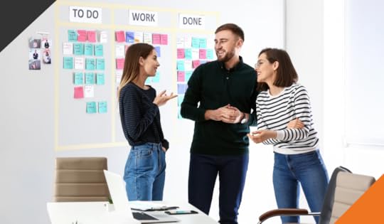 three employees in a meeting room working through task lists demonstrating 4 ways to improve productivity at work