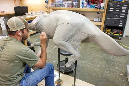Exhibit artist working on sculpting the dinosaur���s body