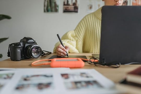 A person using GIMP on their laptop. GIMP is one of the top 10 writing tools I recommend every aspiring YA author uses.