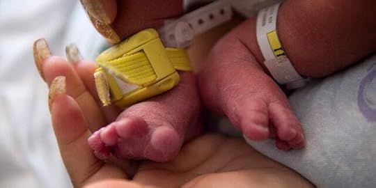 Close up of a mother holding her baby in the hospital