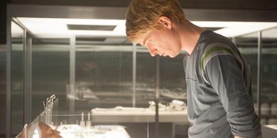 Domhnall Gleeson looks down at faces in a scene from