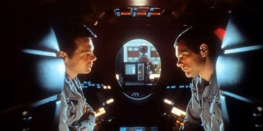 Gary Lockwood and Keir Dullea talk to each other during a scene in what looks like a spaceship from