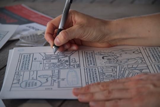 Lucy working on a page of her comic, Mappin' the Floor.