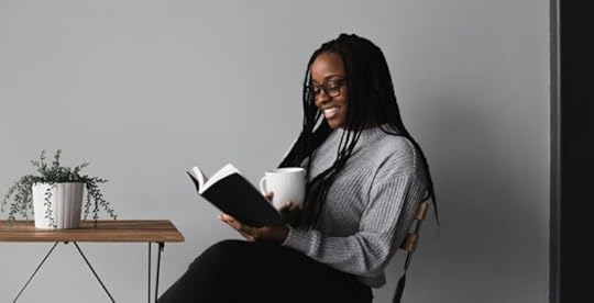 Woman reading a book as part of summer reading goal