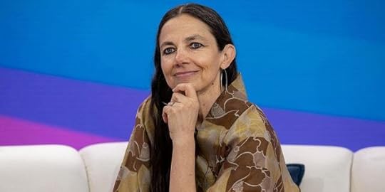 Justine Bateman puts her hand to her chin and soft smiles on the couch at the TODAY show