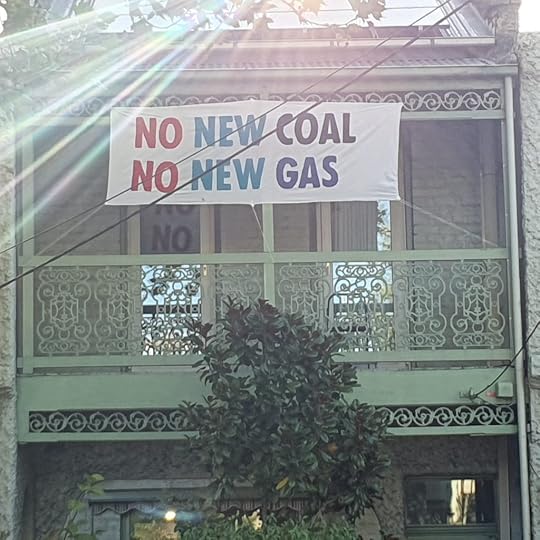 House with sign on balcony that reads 