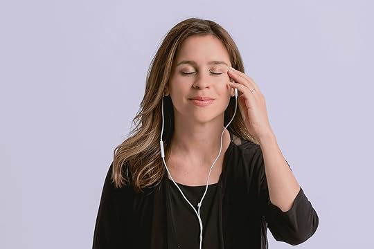 Jessica Ortner with eyes closed tapping on the side of the eye doing EFT Tapping