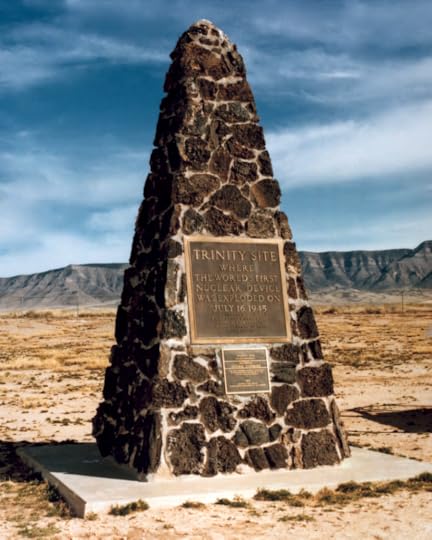 Color photo of stone obelisk with a plaque in the middle.