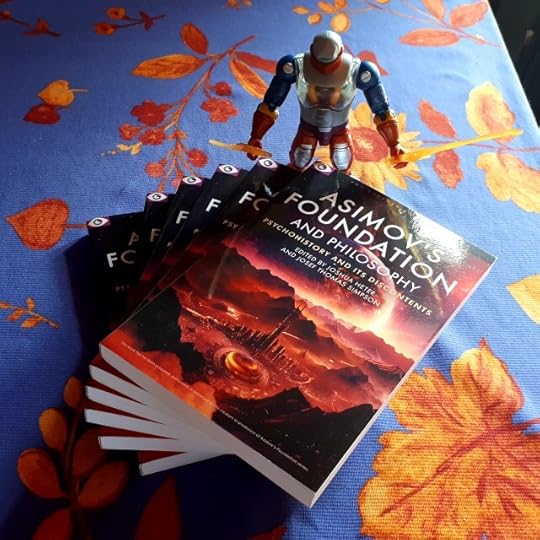 Roboto poses with my contributor copies of Asimov's Foundation and Philosophy