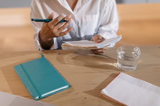 A person writing an ending to their novel.
