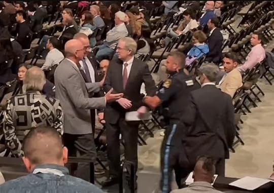 https://healthimpactnews.com/wp-content/uploads/sites/2/2023/05/Peter-Flaherty-was-arrested-at-a-shareholder-meeting.jpg