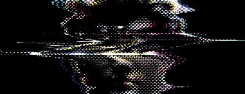 A distorted image of a man's face on a black background, from the title cover of 
