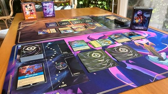 Two Disney Lorcana playmats with the cards set up
