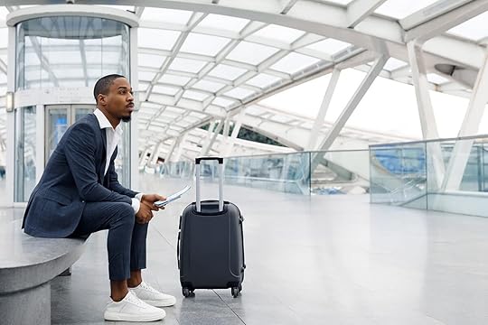 Man in airport with luggage getting ready to fly on an airplane