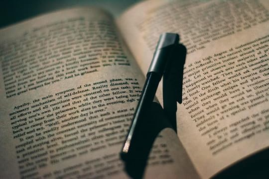A black pen on an open book.