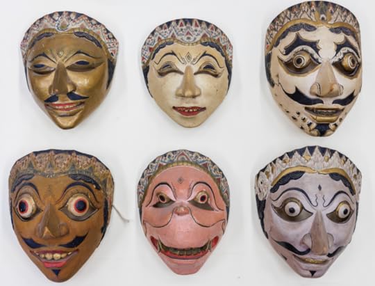 Six colorful Asian theater masks against a white background, showing grotesque faces in an array of expressions