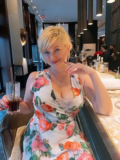 Artist Tatyana Burika in a floral dress.