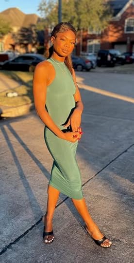 Rapper Tiko Texas looks chic in a green dress.