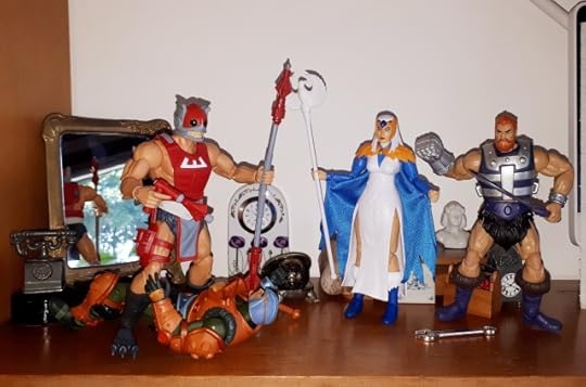 Zodac threatens Duncan with his staff, while the Sorceress and Malcolm look on.