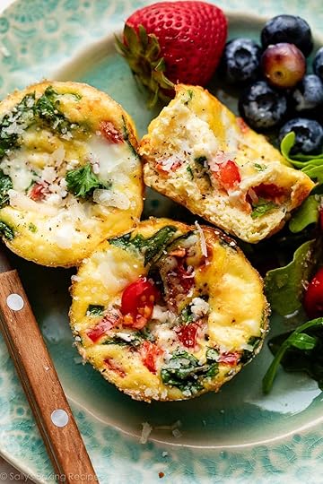 spinach and feta egg muffins on blue plate with berries in background.