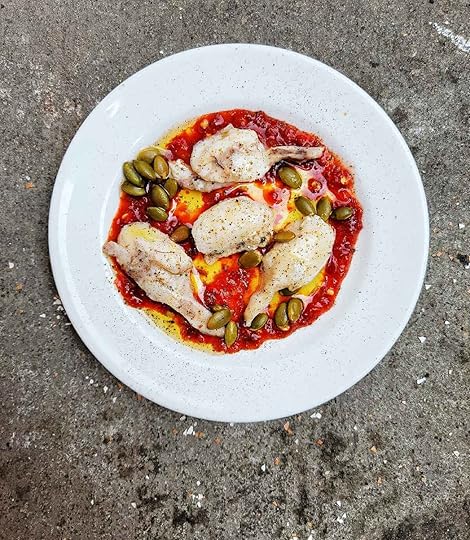 A plate of burbot cheeks with sambal, olive oil, roasted pumpkin seeds and pepper.