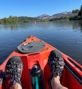 Kayaking a lake wearing Keen sandals